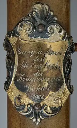 Stockschild bzw. Stocknagel am Fahnenstock des Kriegervereins Wohlde aus dem Jahr 1908