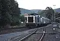 211 035 wartet mit Zug N&nbsp;7608 in Warmensteinach auf die Abfahrt nach Bayreuth, 1991