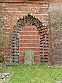 Vermauertes Portal im zweiten Joch der Nord­wand: Form­steine rechts größ­ten­teils neu­zeit­lich ersetzt, links größ­ten­teils mittel­alter­lich; ganz links eine Bau­fuge zwischen zwei Wand­flächen aus mittel­alter­lichem Verband