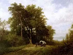 A wagon in a wooded landscape