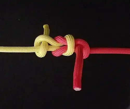 Kreuzknoten auf jeder Seite mit einem Halben Schlag gesichert