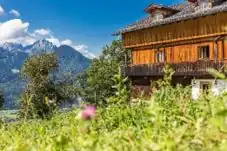Fotografie des Ederhof aus dem Jahr 2019. Gezeigt wird der Ederhof zusammen mit seiner idyllischen Naturlage im Frühsommer 2019.