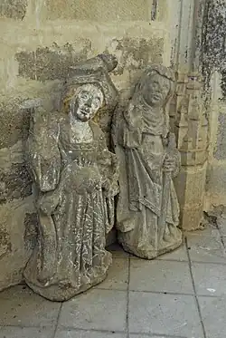 2 Frauen, die linke herrschaftl. gekleidet, die rechte mit Pilgerstab