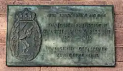Messingschild mit Wappen und Inschrift: ZUR ERINNERUNG AN DAS KÖNIGLICH PREUSSISCHE KADETTENHAUS KARLSRUHE 1892–1919 UND SEINEN GEFALLENEN ZUM GEDÄCHTNIS