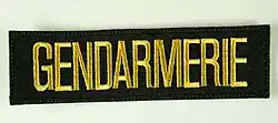 Schriftzug auf den Uniformen der Gendarmerie