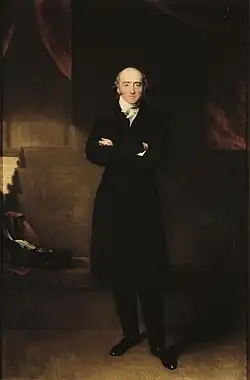 Ein Gemälde Cannings von Thomas Lawrence. Canning steht aufrecht mit verschränkten Armen vor einem dunklen Hintergrund, er trägt einen schwarzen Mantel, darunter ein weißes Hemd. Dazu hat er einen schwarze Hose und schwarze Schuhe an. Er schaut mit gefasstem, ernsten Blick frontal auf den Betrachter.