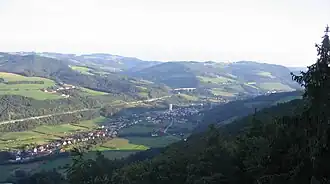 Blick über Grimmenstein und in die Bucklige Welt nach Südosten; am Hang von links geradlinig bis zur Bildmitte die Südautobahn