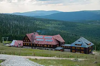 Abstieg zum Berghotel „Schronisko na Hali Szrenickiej“ (von der Szrenica aus gesehen, im Hintergrund das Isergebirge)