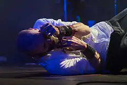 Aaron Stainthorpe liegt auf dem Bühnenboden und hält sich die Hände vor das Gesicht