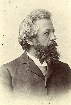 Josef Blaas mit dichtem Vollbart, dunklem Anzug und Blick nach rechts