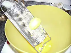 Kartoffelreibe mit geriebener Kartoffel, der sogenannte „Schab“ oder „Reibicht“, gelangt in die Schüssel, später wird es von der Kartoffelstärke getrennt