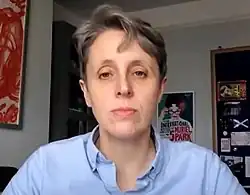 Eine Webcam-Aufnahme einer Frau mit kurzen, grauen Haaren.