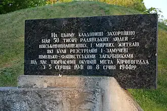 Gedenktafel (Ukrainisch. Auf diesem Friedhof sind 50.000 Menschen begraben – Kriegsgefangene und Zivilisten, die während der Besetzung der Stadt vom 5. August 1941 bis 8. Januar 1944 von den deutschen Invasoren erschossen und gefoltert wurden)