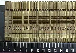 Linotype-Matrizenzeile (Wortabstände wurden in der Regel durch spezielle Wortabstandskeile gebildet)