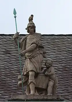 48. Militärwesen – Soldat, Lanze, Putto mit Trommel.