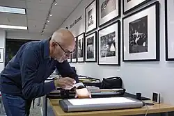 Peter Pfrunder of Fotostiftung Schweiz at Archivalimage Gallery, 2017. Examining Marcel Bolomet Archive.
