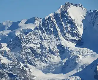 Piz-Bernina-Gipfelaufbau von Nordwesten: Links die Fuorcla Prievlusa mit anschliessendem Biancograt, mittig der Hauptgipfel, links davor der Pizzo Bianco (Piz Alv), rechts Spalla (La Spedla, Südgipfel, Grenze zu Italien), ganz rechts Grat zur Scerscen-Scharte, hinten links Piz Palü, vorn der Vadret da Tschierva