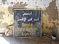 Wegweiser in einem zerstörten Haus: „Bitte lächeln. Du bist in Luxor.“