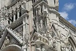 Dichte Dekoration mit Figurenprogramm an der Südwestecke der Fassade, Detail