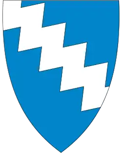Abbildung eines Wappen mit blauem Hintergrund, darauf eine weiße gezackte Fläche
