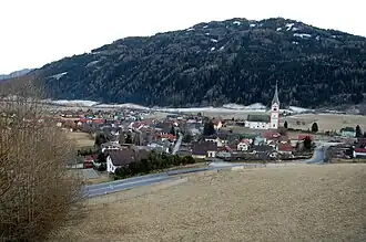 Der Ort St. Peter von Norden aus, von der Auffahrt zum Kammersberg, im Hintergrund die Stolzalpe&nbsp;(1817&nbsp;m&nbsp;ü.&nbsp;A.)