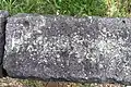Steinrast Sitzbank aus Basaltlava (Ausschnitt) in St Johann Eifel mit vermuteten Schriftzeichen