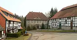 Ortsansicht mit früherer Scheune der Glasfabrik, Herrenhaus und Glashüttengebäude