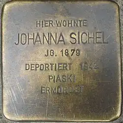 Das Foto zeigt eine Aufsicht auf den Stolperstein für Johanna Sichel. Er trägt die Inschrift: „HIER WOHNTE JOHANNA SICHEL JG. 1879 DEPORTIERT 1942 PIASKI ERMORDET“