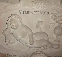 Stiftskirche St.&nbsp;Georg, Tübingen. Detail von einem der Grabmonumente: Memento mori. Dem Stil nach (Putte) aus dem Barock.