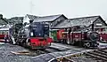 Garratt-Dampflok NGG 87 und Double-Fairlie Merddin Emrys im Hafenbahnhof von Porthmadog