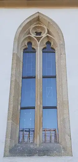 Frühgotisches Maßwerkfenster an der Nordfassade mit zwei Nonnenköpfen und Vierpass