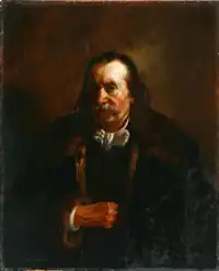 Das Bild zeigt ein Selbstbildnis des Malers Waldemar Knoll (1863). Der Hintergrund ist dunkel und in Brauntönen gehalten, was eine ruhige und klassische Atmosphäre schafft. Der Künstler trägt einen dunklen Mantel, unter dem ein weißes Hemd hervorschaut. Die Hände des Künstlers sind in einer ruhigen Haltung sichtbar, und die Details der Kleidung sind fein ausgearbeitet. Die Beleuchtung hebt die Konturen des Mantels und des Hemdes hervor, während der Rest des Bildes in gedämpften Farben gehalten ist, was den Gesamtcharakter des Bildes unterstreicht.