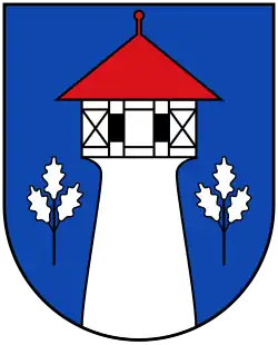 In Blau ein silberner Turm mit sich nach oben verjüngendem Schaft, ausladendem Geschoss und zwei schwarzen Fenstern in schwarzem Fachwerk (Neverin)