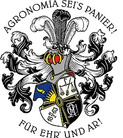 Das Wappen in der Form eines Wappenschildes wird durch ein Kreuz in vier gleiche Felder geteilt. In der Draufsicht werden oben links sind auf blauem Grund die aufgehende Sonne und das goldene Füllhorn Fortunae, oben rechts im weißen Feld werden die Waage der Gleichheit neben dem Schwert der Gerechtigkeit dargestellt. Unten links findet sich im weißen Feld das Gründungsdatum, der 11. Februar 1863, unten rechts im schwarzen Feld der weiße Zirkel.
