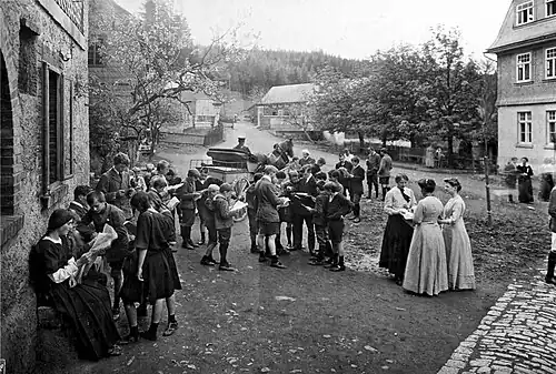 Ausgabe privater Briefe durch den Postkutscher auf dem Hof (1911)