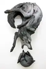 Title: “The Question That Devours” Year: 2012 Dimensions: H 64 × W 35 × D 25 in. Materials: Stoneware, paint Installation: Wall Piece